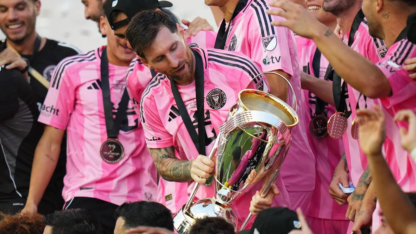 Lionel Messi holding the 2025 MLS Cup beside celebrating Inter Miami teammates